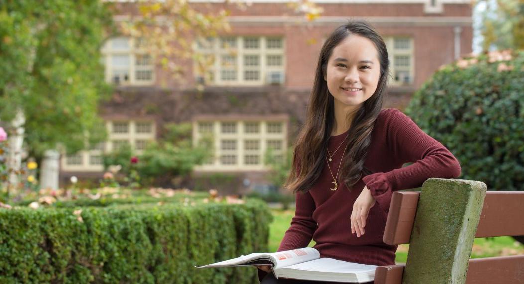 Language student sitting on bench